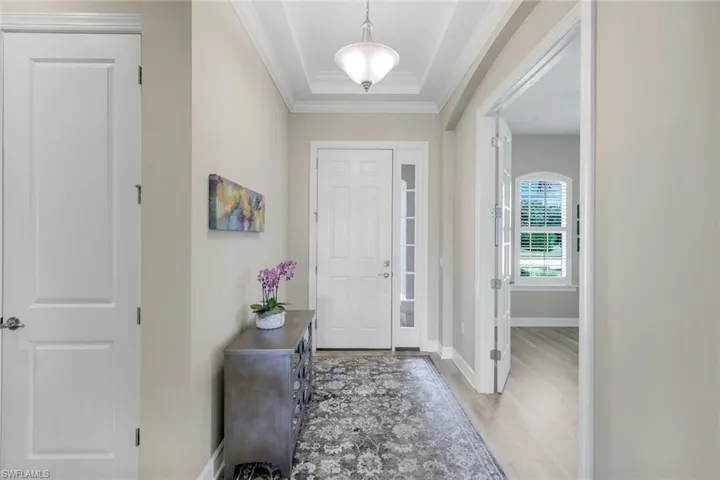 Entrance foyer featuring Decorative ceiling with crown molding