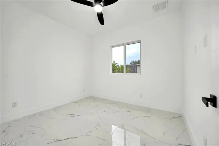 Spare room with ceiling fan