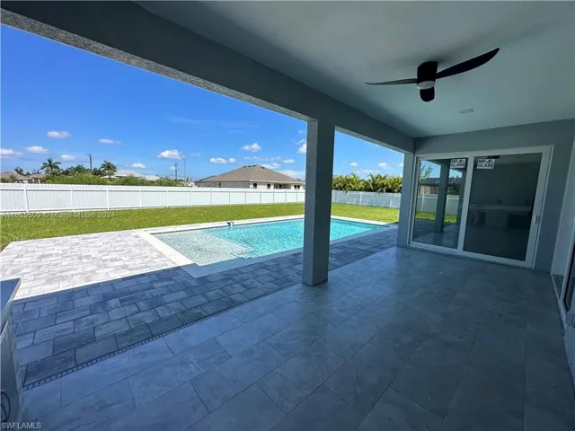 View of pool featuring ceiling fan and a patio