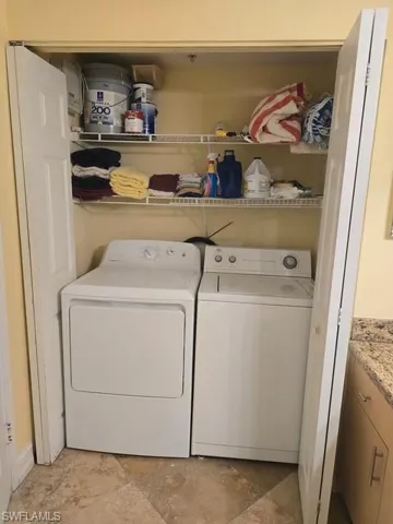 Laundry area featuring washing machine and clothes dryer