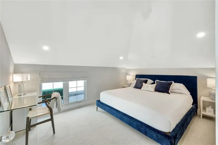 2nd floor bedroom with baseboards and lofted ceiling