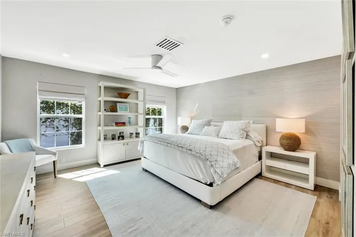 Primary Bedroom featuring a ceiling fan, baseboards, and light wood-type flooring