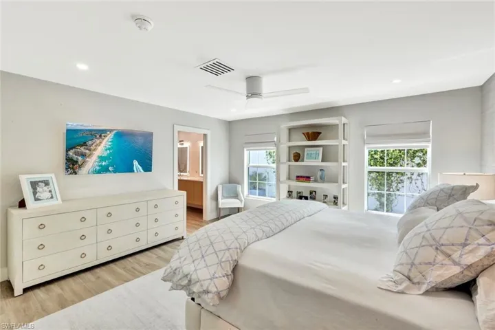 Primary Bedroom with a ceiling fan, recessed lighting, visible vents, and light wood-type flooring