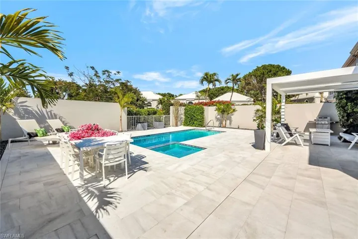 View of swimming pool with a grill, a fenced backyard, and a patio area