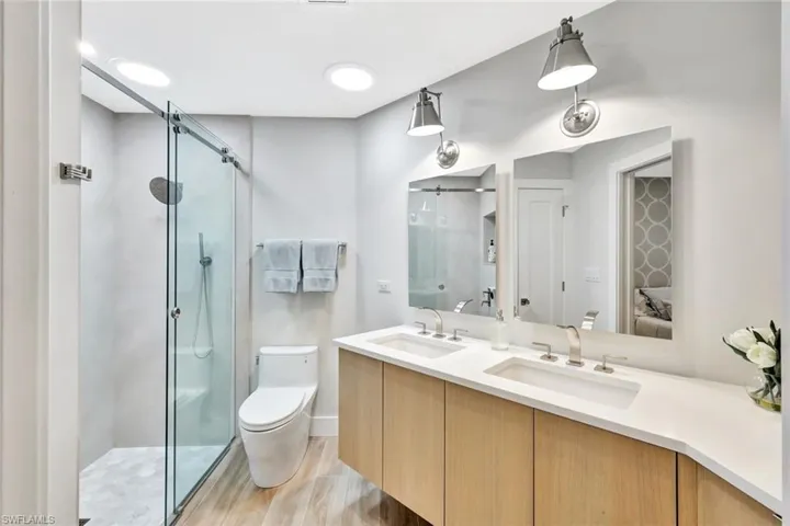 2nd Ensuite bathroom with a sink, double vanity, and a shower stall