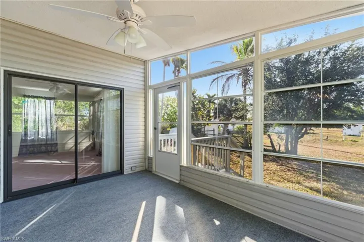Unfurnished sunroom with ceiling fan