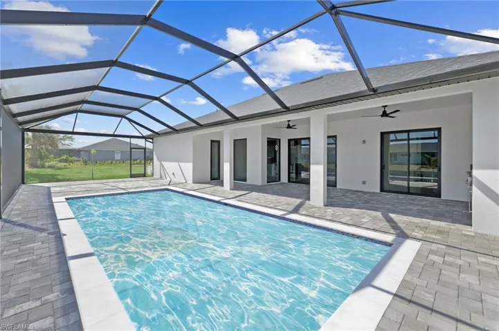 Pool featuring a lanai, a patio area, and a ceiling fan