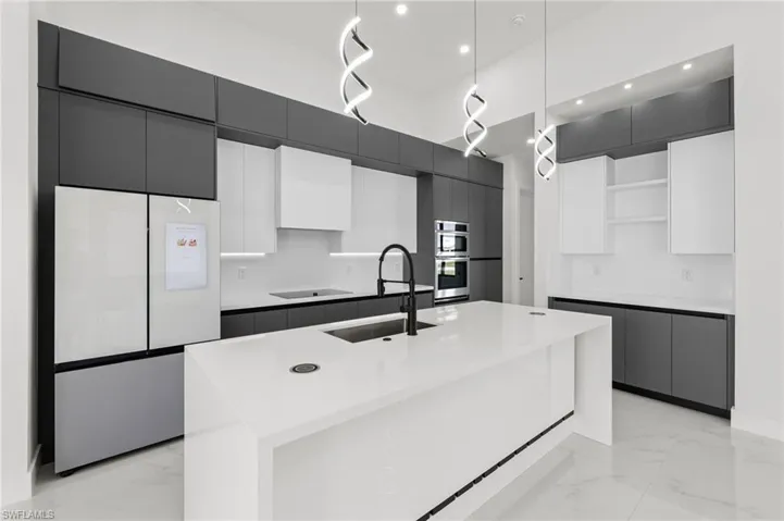 Kitchen featuring open shelves, modern cabinets, a sink, refrigerator with glass door, and marble finish floor