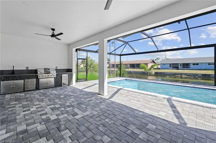 Outdoor pool with a patio, a lanai, area for grilling, and ceiling fan