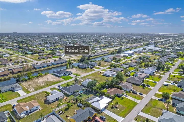 Birds eye view of property featuring a water view and a residential view