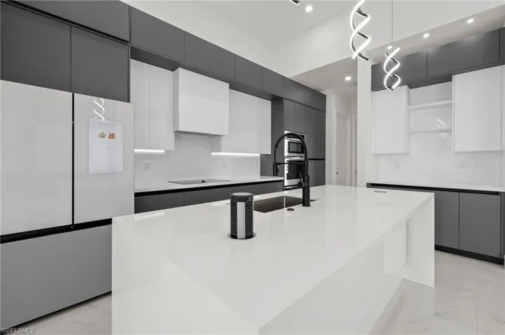 Kitchen with open shelves, modern cabinets, a sink, fridge, and marble finish floor