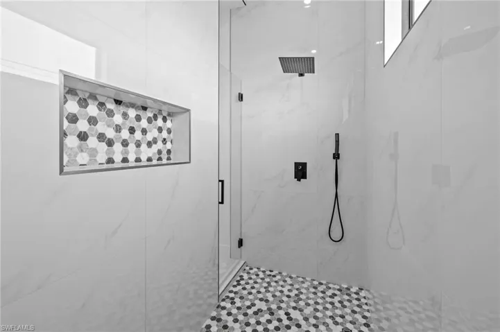 Bathroom featuring a marble finish shower