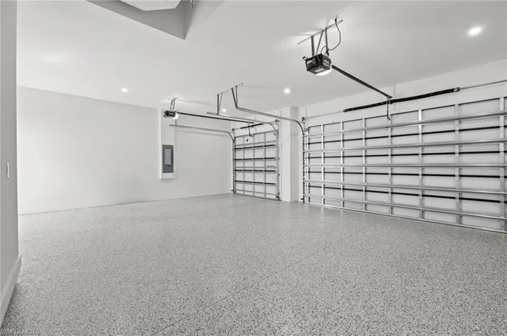 Garage with a garage door opener and electric panel
