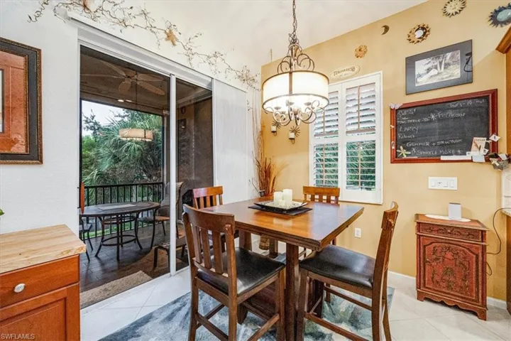 Tiled dining room featuring a chandelier