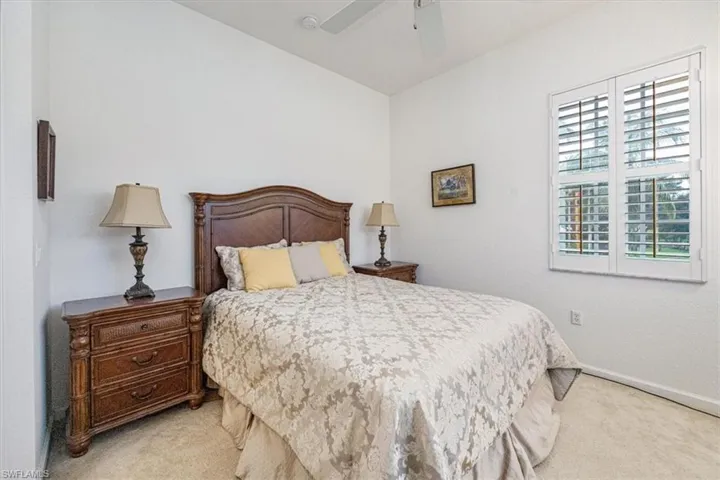 Bedroom featuring light carpet and ceiling fan