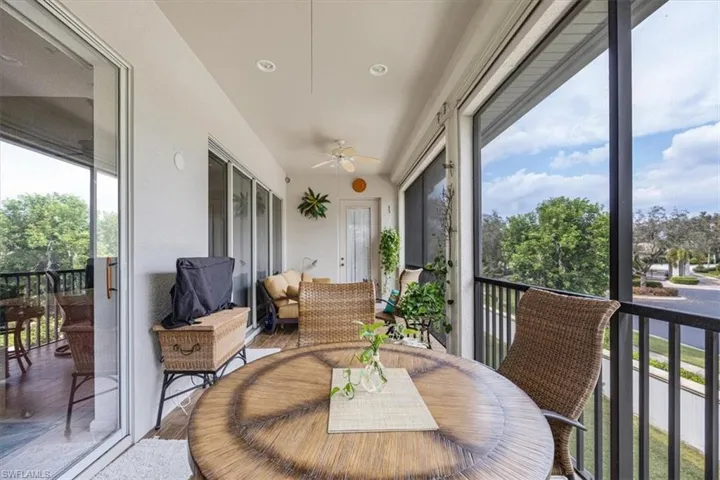 Sunroom featuring ceiling fan and a wealth of natural light