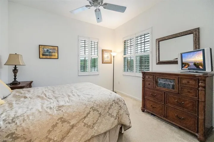 Bedroom with light carpet and ceiling fan
