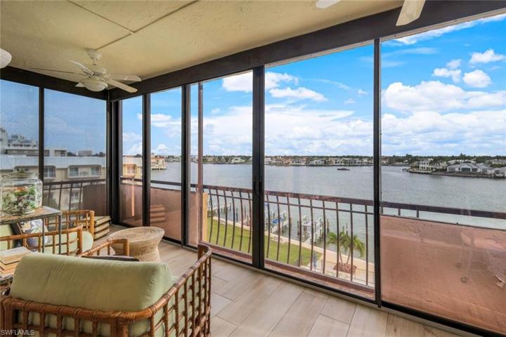 Waterfront enclosed lanai is an all seasons room that is perfect for curling up with a good book and cup of tea