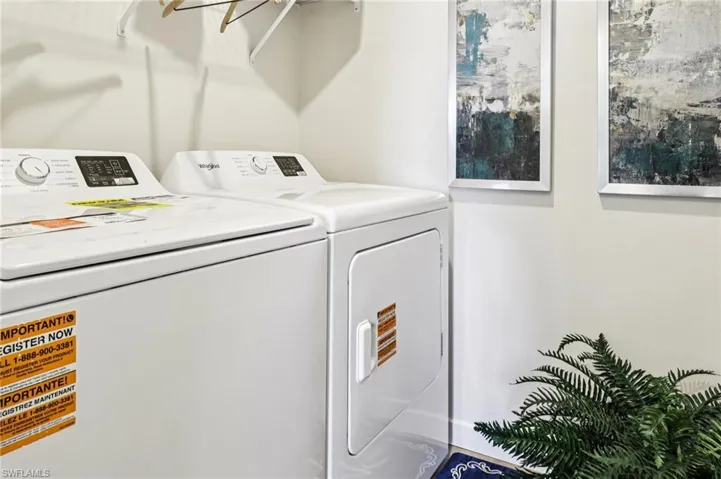 Model home. Laundry room with washer and clothes dryer