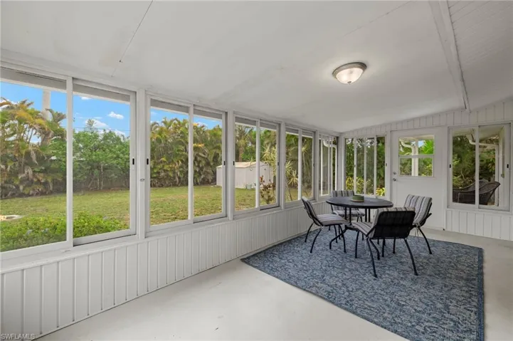 Sunroom / solarium featuring outdoor dining area