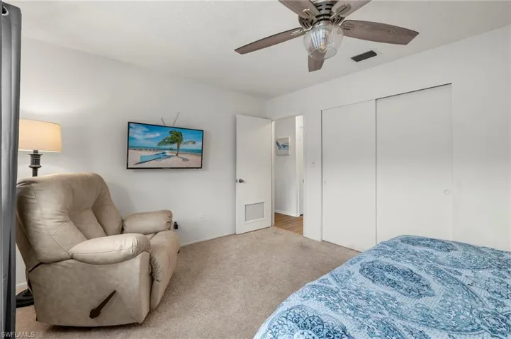 Bedroom featuring carpet, a ceiling fan, a closet, and baseboards