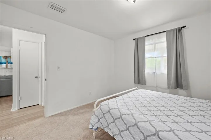 Carpeted bedroom with baseboards