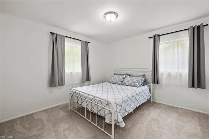 Bedroom with carpet floors and baseboards