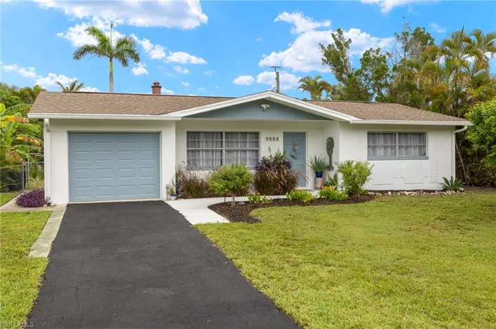 Ranch-style home featuring an attached garage, asphalt driveway, and stucco siding