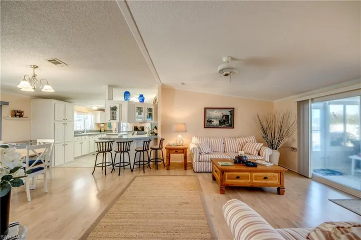 Living area with light wood-style floors and ornamental molding