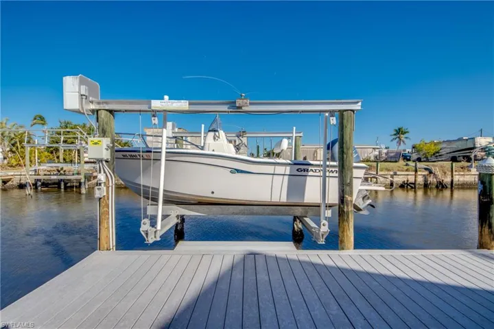 Dock featuring boat lift and a water view