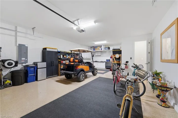 2.5 Car Garage with Epoxy finished floor & built in cabinetry.  The golf cart stays with the home.