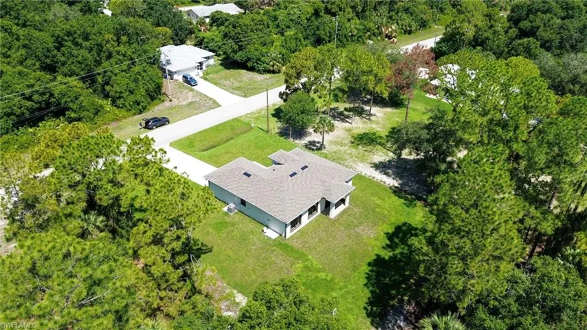 Single-story residence set on a spacious, treed lot with green lawn
