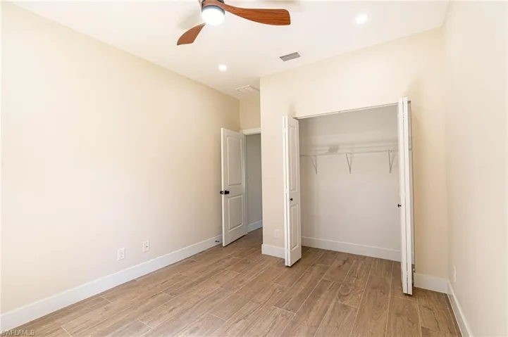 Room featuring wood-finish flooring, recessed lighting, and a ceiling fan