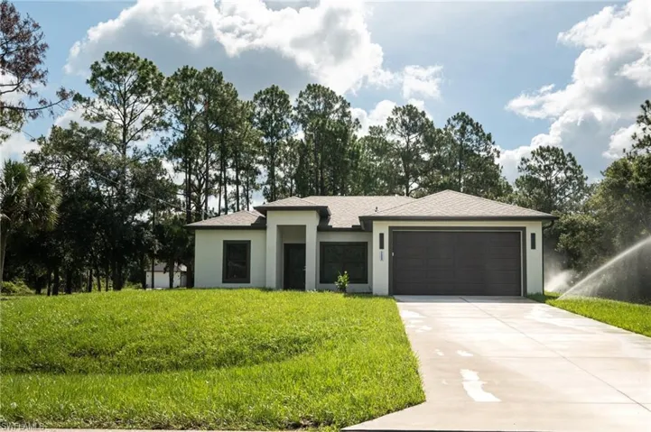 Contemporary stucco home with a dark shingle roof and an attached two-car garage