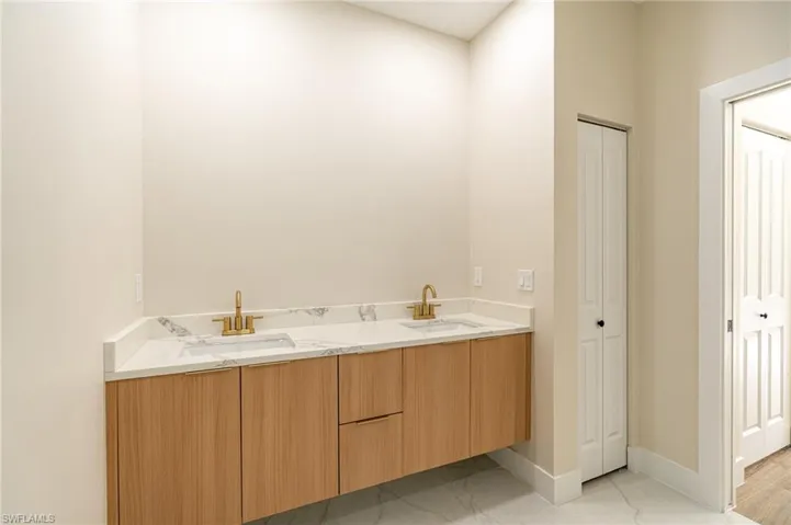 Dual vanity with a white countertop and integrated rectangular sinks