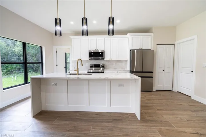 Modern kitchen island with a white countertop and panel detailing