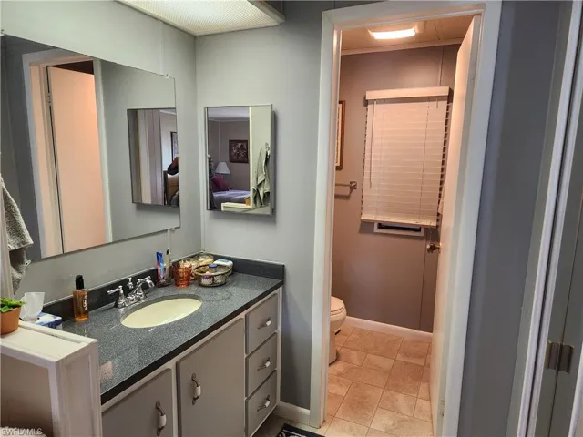 Bathroom with tile patterned floors, toilet, and vanity