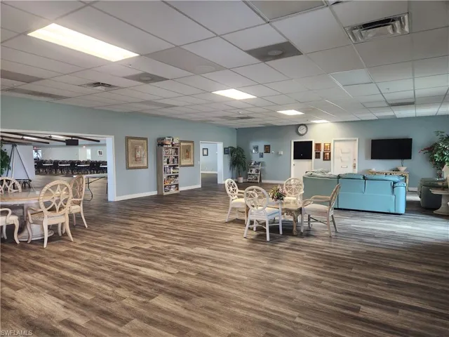 Dining space featuring dark hardwood / wood-style flooring and a paneled ceiling