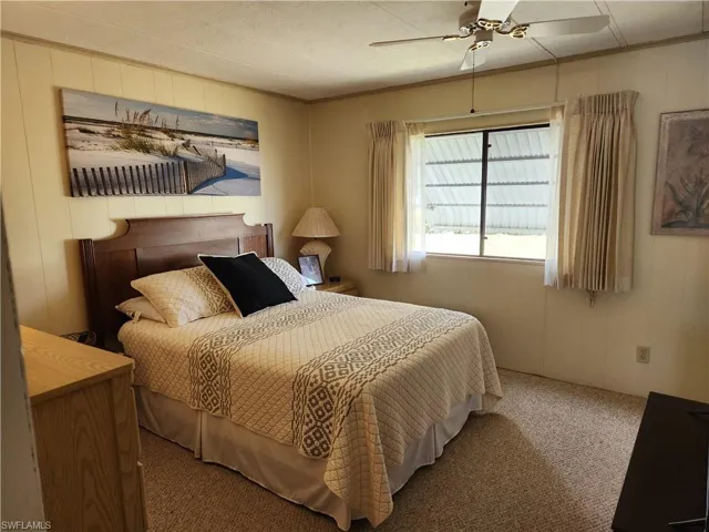 Carpeted bedroom with ceiling fan