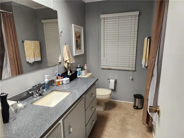 Bathroom with tile patterned floors, vanity, and toilet