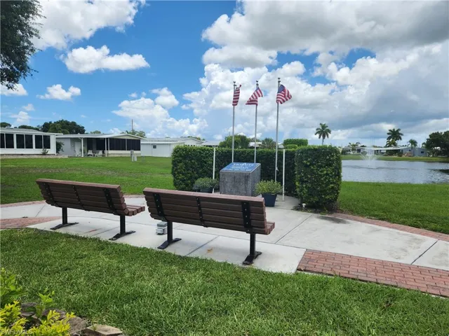 View of home's community featuring a yard and a water view