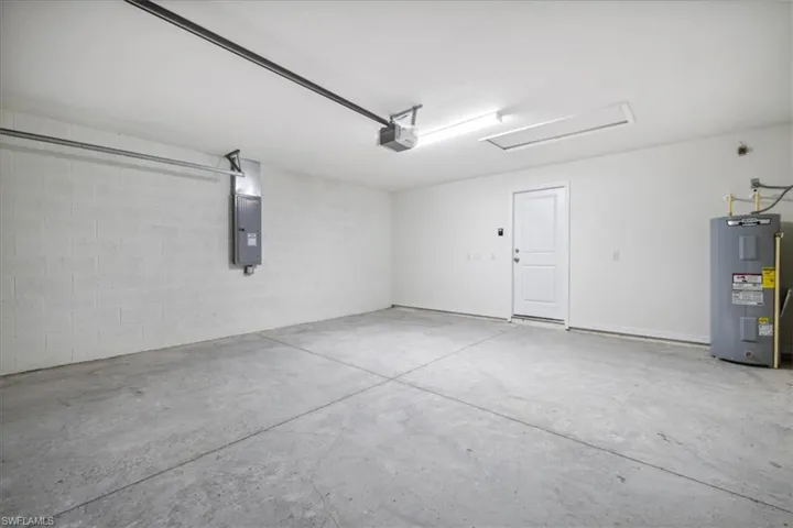 Garage with a garage door opener and electric water heater
