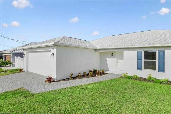 View of property exterior with a yard and a garage