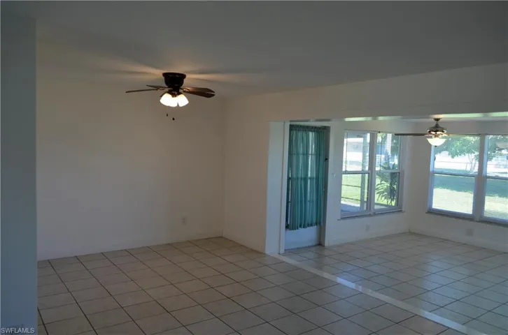 Unfurnished room featuring ceiling fan and light tile patterned floors