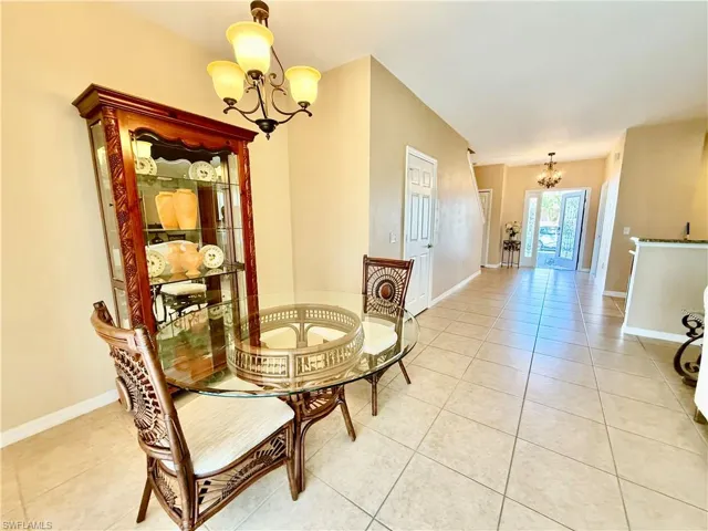 Dining room featuring a chandelier and light tile floors