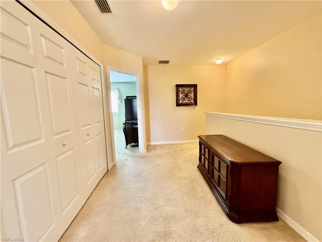 Hallway with light carpet