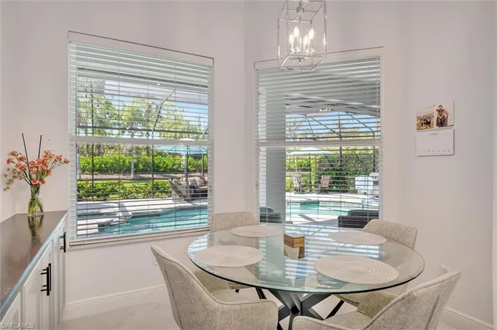 Dining room featuring light tile patterned flooring and a chandelier