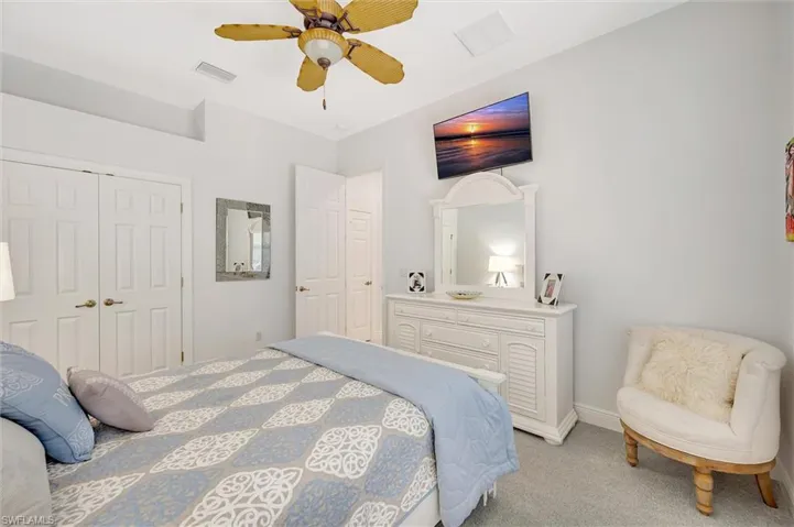 Bedroom with carpet flooring, a ceiling fan, and a closet