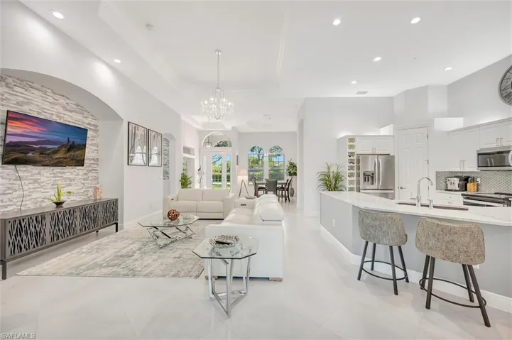 Living room featuring recessed lighting and a chandelier