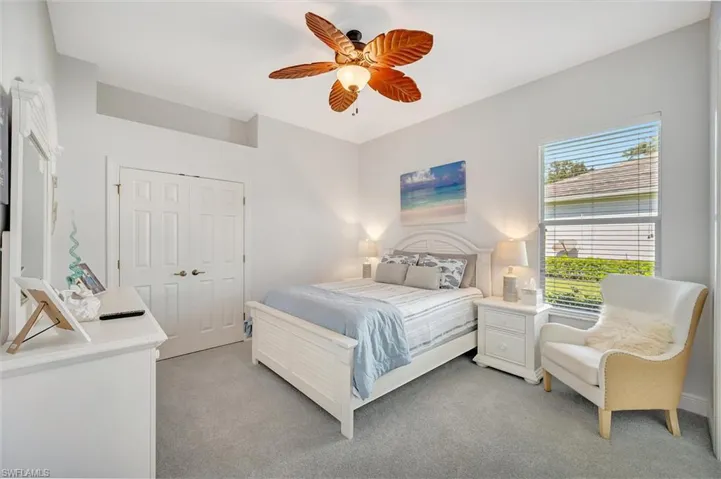 Bedroom featuring carpet, a ceiling fan, and a closet